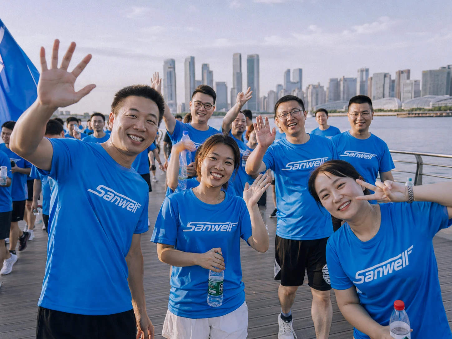 SANWELL LOGISTICS team members waving during a team activity