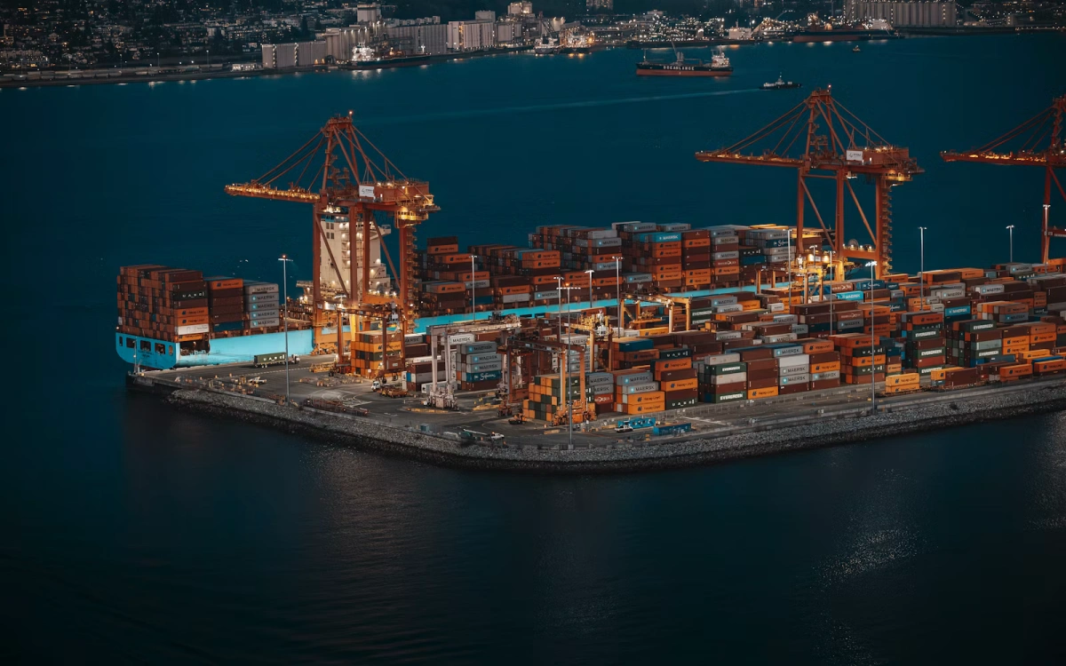 Container ship and cranes at a busy shipping port for ocean freight operations
