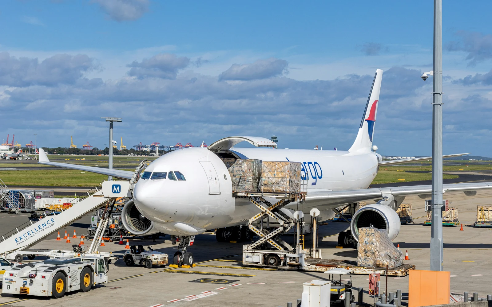 Cargo aircraft being loaded with palletized freight on the airport apron