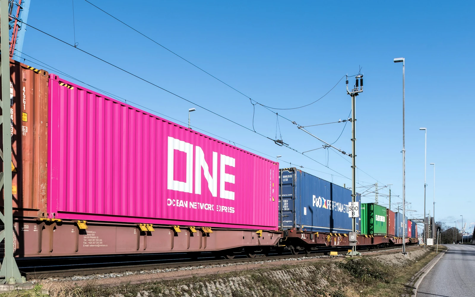 Container freight train moving through an intermodal rail corridor
